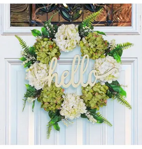 Detailed view of artificial hydrangea wreath with wooden hello sign on a white door