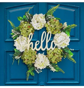 Detailed view of artificial hydrangea wreath with wooden hello sign on a blue door