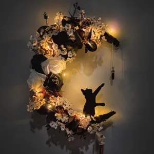 Halloween moon cat wreath decoration with black and white roses and warm LED lights
