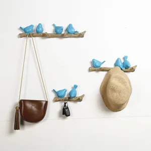 Nordic style decorative resin bird wall hooks showing usage with bag and hat on wall