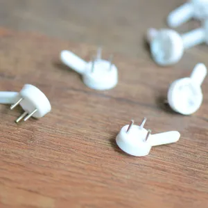 Close-up of white plastic non-trace hooks with three steel pins for frames