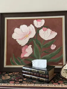 Vintage European book-style wooden tissue box placed on a patterned table runner.