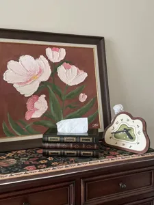 Close-up view of a retro book-shaped wooden tissue box in a vintage home decor setting.