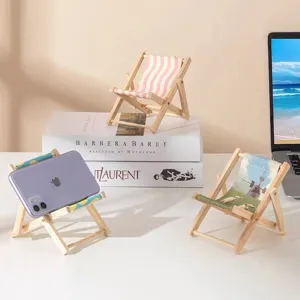 Miniature wooden folding beach chair phone stand for cute desk decor and desktop ornament