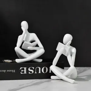 Figuritas de pensador abstractas modernas en resina blanca leyendo para decoración