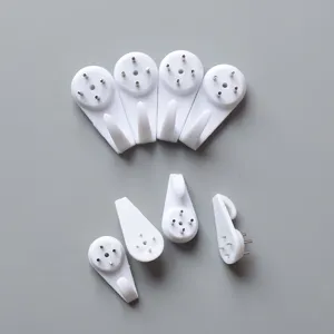Set of seven white plastic invisible no-trace wall hooks for hanging photo frames