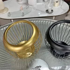 Detail view of gold and black minimalist iron wire baskets for coffee capsule storage