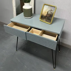 Detail showing two open drawers with wooden interior of modern gray minimalist vanity table.