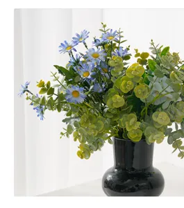 Macro view showing realistic textures of artificial blue daisy and eucalyptus leaves