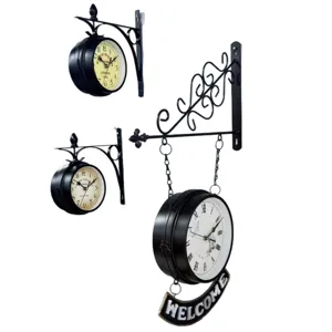 Vintage double-sided wrought iron wall clocks with classic Roman and Arabic numerals