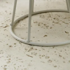 Detail view of a minimalist white metal circular base for a tiered dessert display stand.