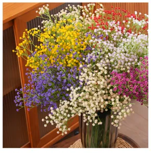 Vibrant colorful artificial baby's breath flowers displayed in a glass vase for home decor