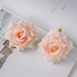 Close-up of champagne silk rose heads with realistic curled petals for decor.