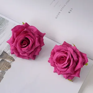 Detailed view of two magenta artificial rose heads made of high-quality silk fabric.