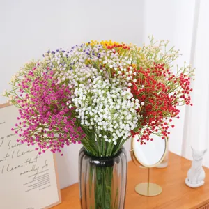 Colorful artificial baby's breath flowers in a glass vase for home wedding decor