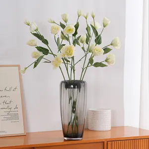 Elegant artificial lisianthus flowers in a grey glass vase for modern home decor