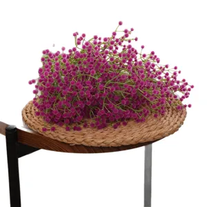 Vibrant magenta artificial baby's breath flowers for wedding decor on a woven mat