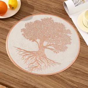 A detailed macro view showing the rose gold Tree of Life design on a white round PVC placemat.