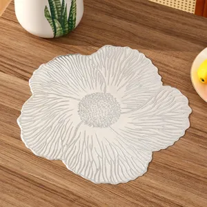 Detailed macro view of French romantic floral PVC placemat with embossed silver texture