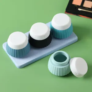 Detail of portable silicone travel cream jars with one open to show interior