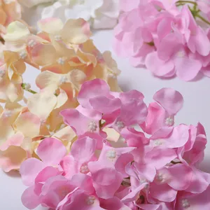 Close-up detail of artificial pink and cream hydrangea flowers showing delicate petal texture.