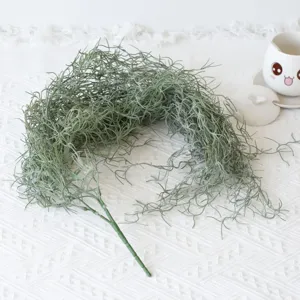 Macro detail of artificial green air vine plant with realistic fuzzy texture on white table