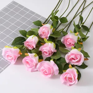 Detailed view of nine elegant pink artificial snow mountain roses with silk petals