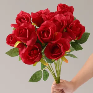 Detailed view of vibrant red artificial roses with realistic silk petals and leaves