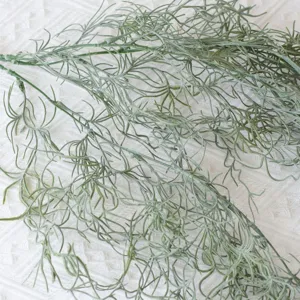 Detailed close-up of green artificial air fern vine with realistic fuzzy texture