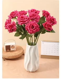 Vibrant magenta artificial rolled-edge roses in a white wavy vase for home decor