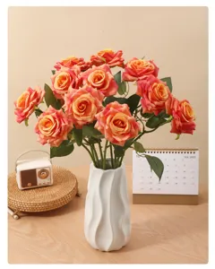 Detail of artificial curled-edge roses in a white ceramic vase for home decoration