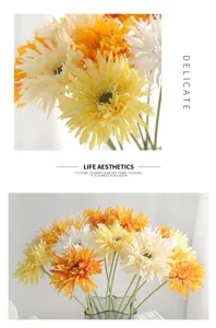 Modern minimalist white and orange artificial Gerbera flowers in a glass vase decor