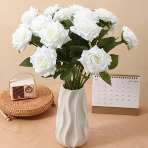 Elegant bunch of white artificial rolled-edge roses in a white ceramic vase for home