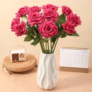 Artificial magenta rose bouquet in white twisted vase for home decoration