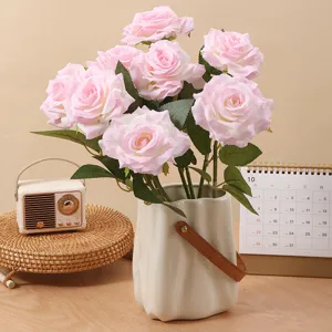 Elegant realistic pink artificial curled roses in a textured ceramic vase for home decor