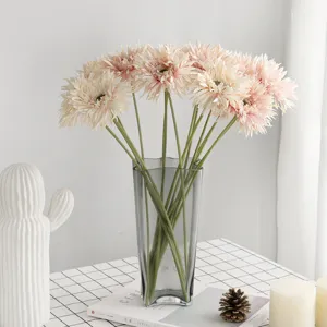Elegant artificial light pink Gerbera daisy flower stems in a modern grey glass vase