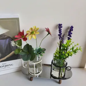 Modern cup-shaped glass vases with iron frames on a metal tray for home decoration.