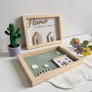 Detail of pastoral wooden frames with Home is where the heart is and cottage 3D elements.
