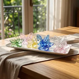 Detail view of colorful crystal glass flower ornaments on a white decorative tray