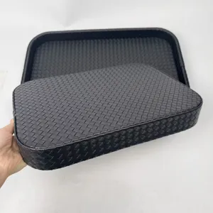 Detail view of black woven PU leather rectangular storage trays for home decor