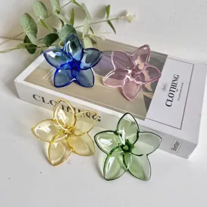 Four colorful crystal glass flower ornaments displayed on a lifestyle background