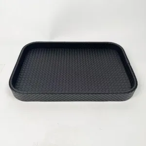Close-up of black woven leather storage tray with rectangular rounded design.
