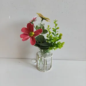 Clear glass hydroponic vase featuring a minimalist white metal cup-shaped wire frame