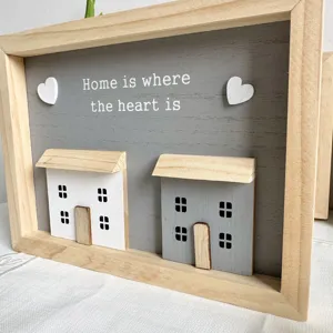Detailed view of a Nordic style wooden frame with 'Home is where the heart is' quote