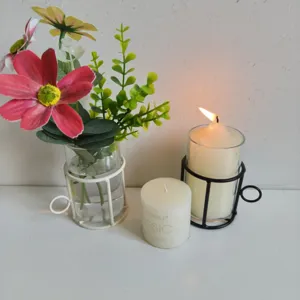 Detail view of creative glass cylinder vase with iron frame and romantic candle holder set