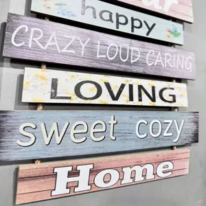 Close-up detail showing the wood grain and printed text on a rustic hanging wall plaque