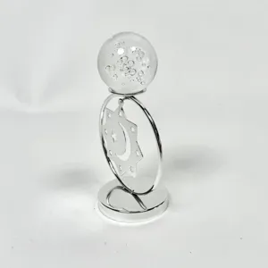 Detalle de adorno de hierro plateado con bola de cristal y patrón de estrella y luna de mesa