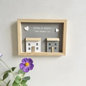 Detail of Nordic wooden shadow box with Home is where the heart is quote and 3D houses