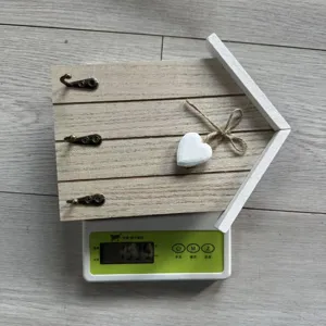 Nordic style wooden house wall hook weight measurement showing 153.5 grams on a digital scale