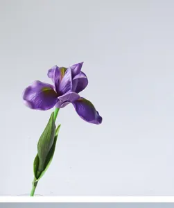 Detailed view of a single purple artificial PU iris flower with green stem for elegant decor.